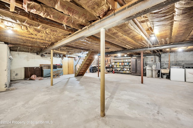 basement with washer and clothes dryer and sink