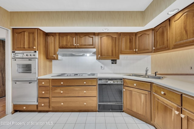 kitchen featuring decorative backsplash, sink, light tile patterned flooring, and white appliances