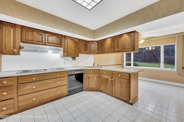 kitchen featuring sink, decorative backsplash, light tile patterned floors, black dishwasher, and a baseboard radiator