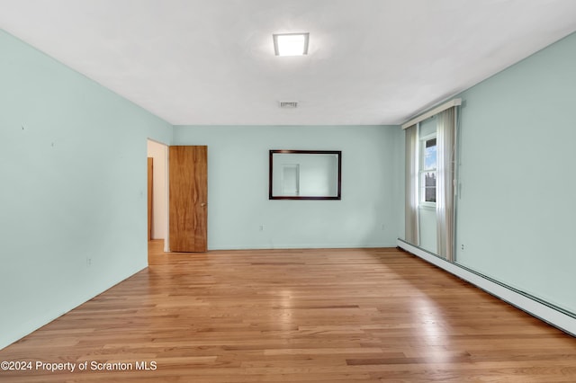 spare room with light hardwood / wood-style floors and baseboard heating