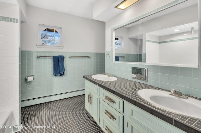 bathroom featuring tile patterned flooring, vanity, tile walls, and a baseboard heating unit