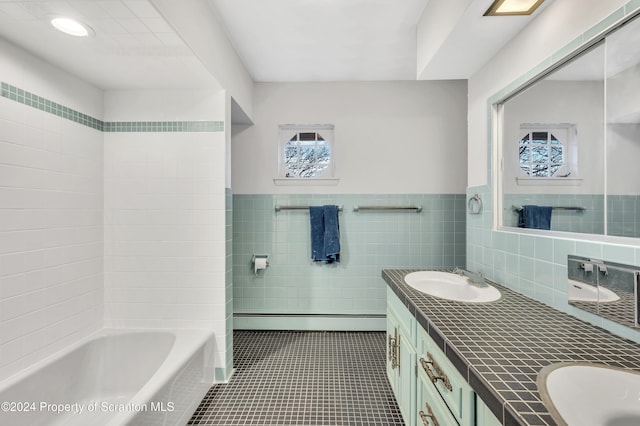 bathroom with tile patterned floors, vanity, tile walls, and a baseboard heating unit