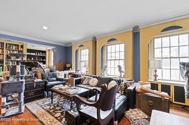 living room with wood finished floors and ornamental molding