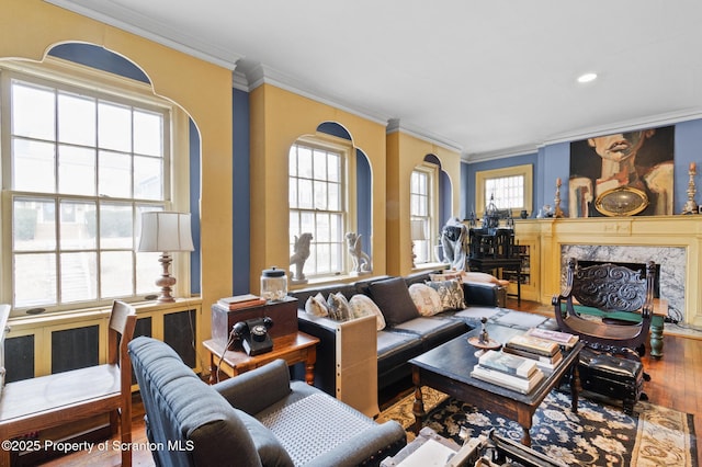 living room featuring crown molding, recessed lighting, wood finished floors, and a high end fireplace