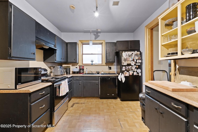 kitchen with visible vents, black appliances, under cabinet range hood, a sink, and light countertops