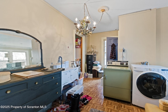 laundry room featuring a notable chandelier, washer / clothes dryer, and crown molding