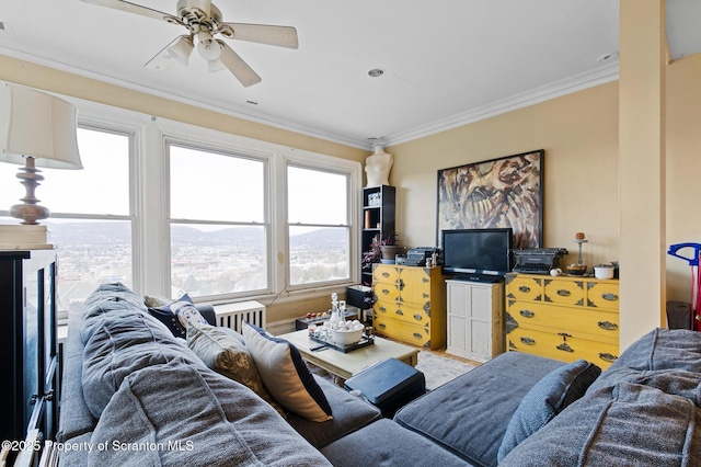 living room with ceiling fan and ornamental molding