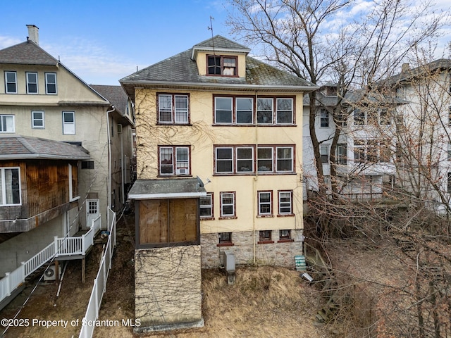 back of property featuring stucco siding