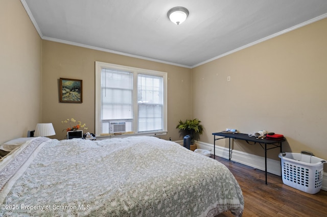 bedroom featuring cooling unit, baseboards, dark wood-style flooring, and crown molding