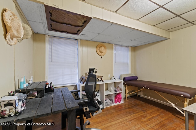 office area with a paneled ceiling and wood-type flooring