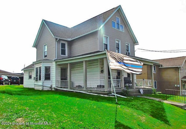 exterior space featuring covered porch and a yard