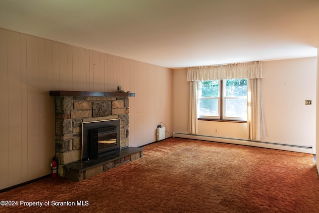 unfurnished living room with wooden walls, a fireplace, carpet floors, and a baseboard radiator