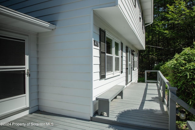 view of property exterior with a deck