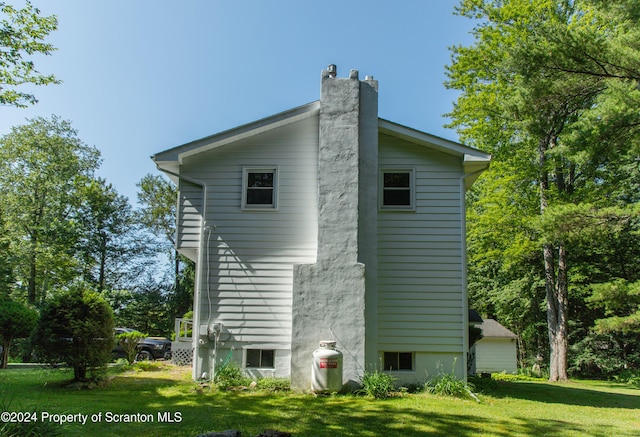 view of property exterior with a yard