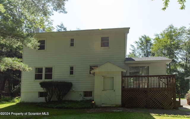 back of house featuring a wooden deck