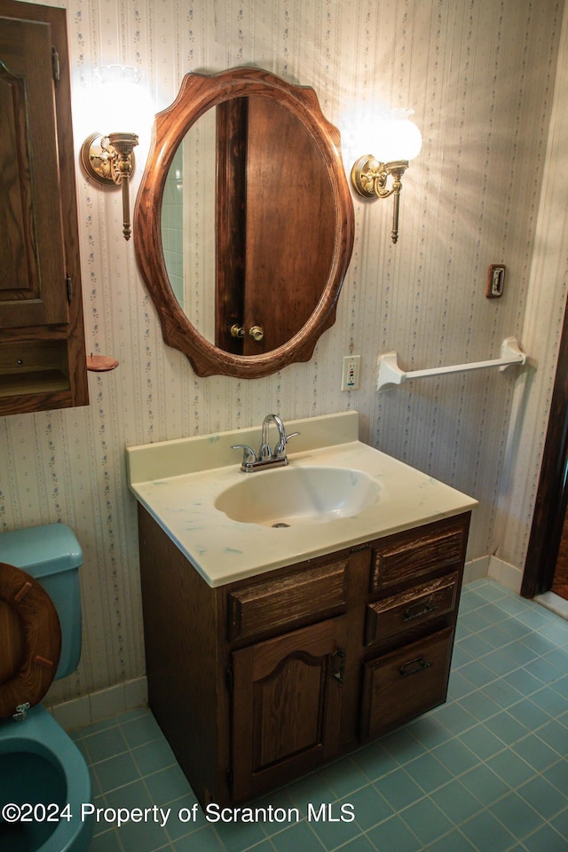 bathroom featuring tile patterned floors, vanity, and toilet