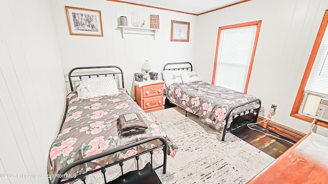 bedroom featuring ornamental molding and wood walls