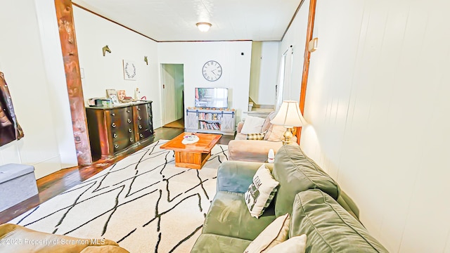 living room featuring hardwood / wood-style floors and crown molding