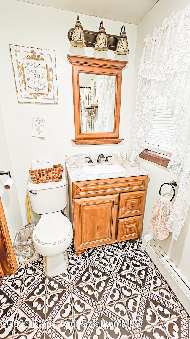 bathroom featuring tile patterned floors, vanity, and toilet