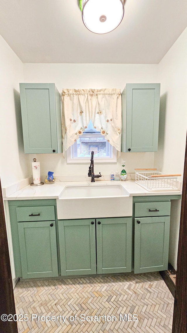 kitchen with green cabinetry and sink