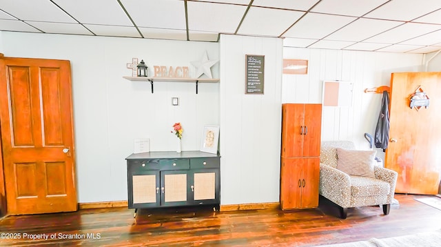 sitting room with dark wood-type flooring