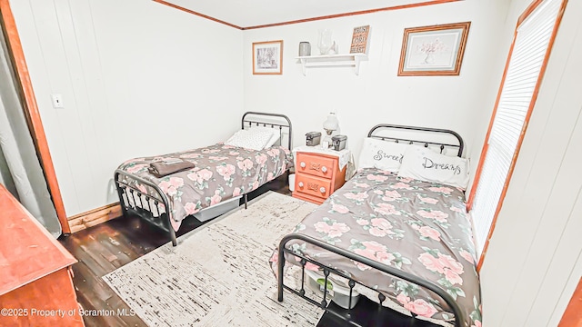 bedroom featuring hardwood / wood-style flooring, a closet, and crown molding