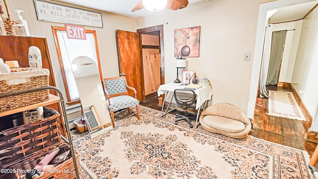 living area featuring hardwood / wood-style flooring and ceiling fan