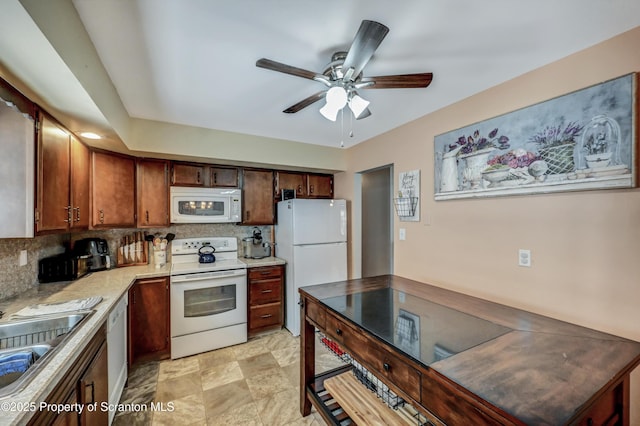 kitchen featuring ceiling fan, white appliances, sink, and decorative backsplash