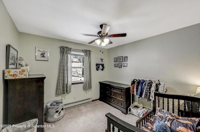 carpeted bedroom with a baseboard heating unit and ceiling fan