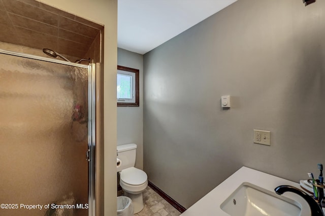 bathroom featuring sink, toilet, and walk in shower