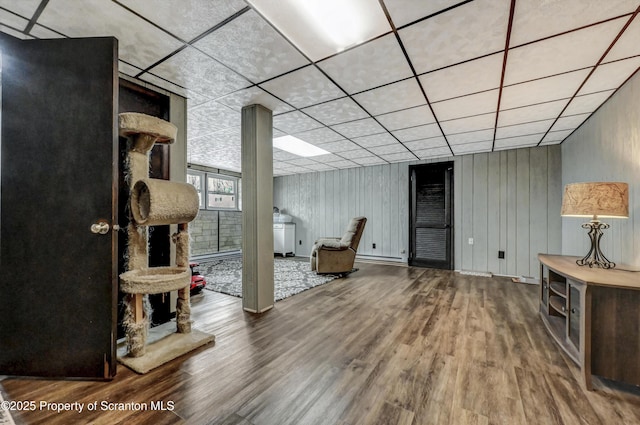 living room featuring a paneled ceiling and hardwood / wood-style floors