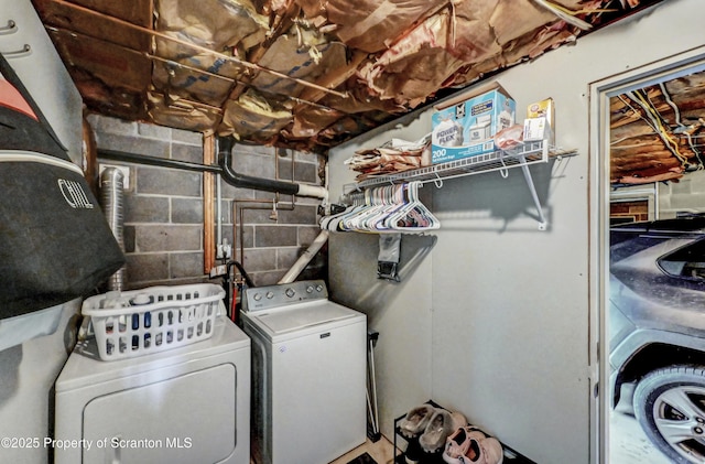 clothes washing area with washer and clothes dryer