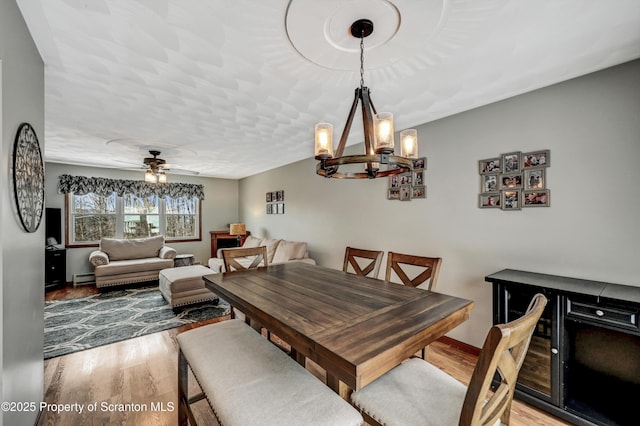 dining area with ceiling fan and light wood-type flooring