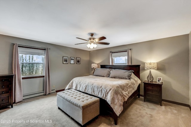 bedroom with ceiling fan, light colored carpet, and a baseboard heating unit