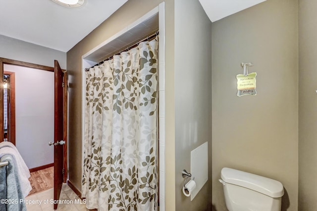 bathroom with toilet and walk in shower