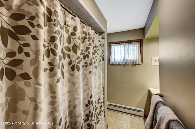 bathroom featuring tile patterned flooring, a baseboard heating unit, and a shower with curtain