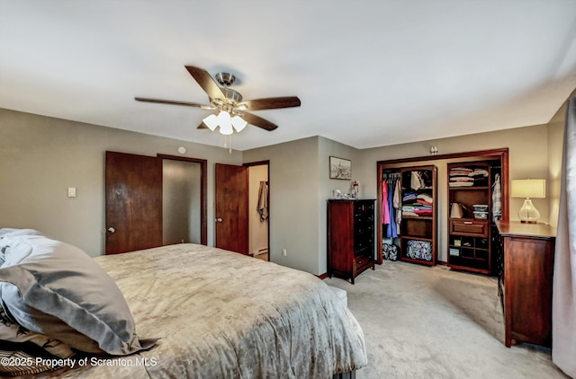 bedroom with ceiling fan, light colored carpet, and a baseboard heating unit