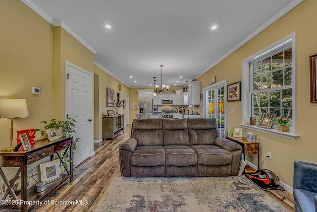 1612 Whitetail Run, Moscow, PA 18444 - living area featuring recessed lighting, wood finished floors, crown molding, and a chandelier