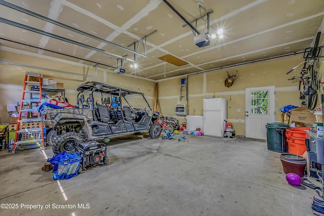 1612 Whitetail Run, Moscow, PA 18444 - garage with freestanding refrigerator and a garage door opener