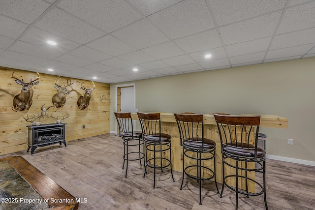 1612 Whitetail Run, Moscow, PA 18444 - indoor dry bar with a wood stove, wood finished floors, recessed lighting, and a paneled ceiling