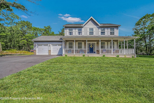 1612 Whitetail Run, Moscow, PA 18444 - view of front of property featuring covered porch, an attached garage, driveway, and a front yard