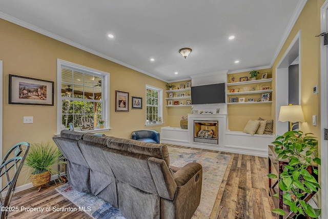 1612 Whitetail Run, Moscow, PA 18444 - living room with wood finished floors, crown molding, recessed lighting, and a fireplace