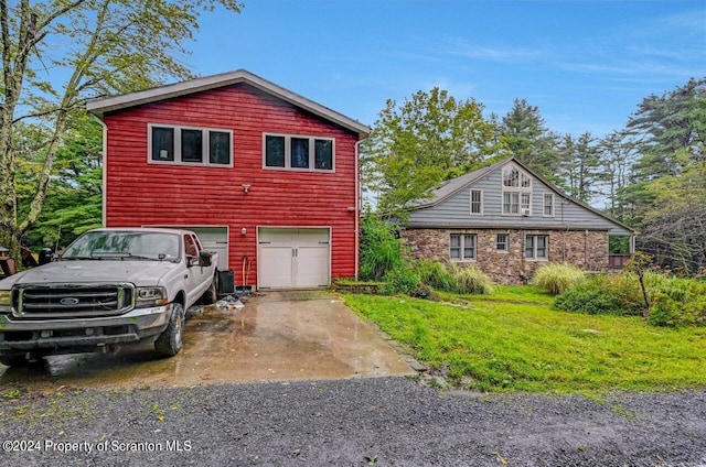 exterior space with a yard and a garage