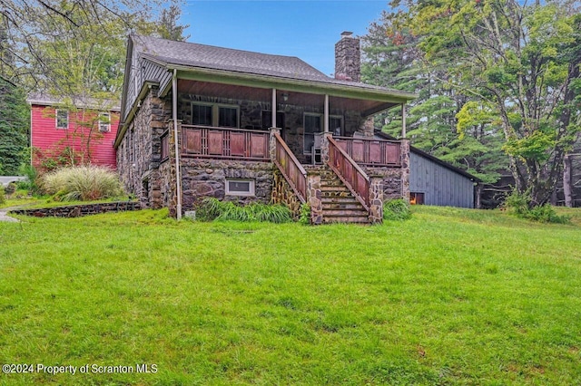 back of property featuring a lawn