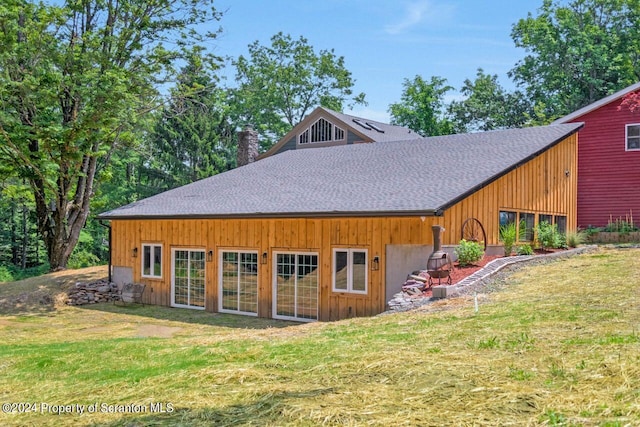 rear view of property with a yard