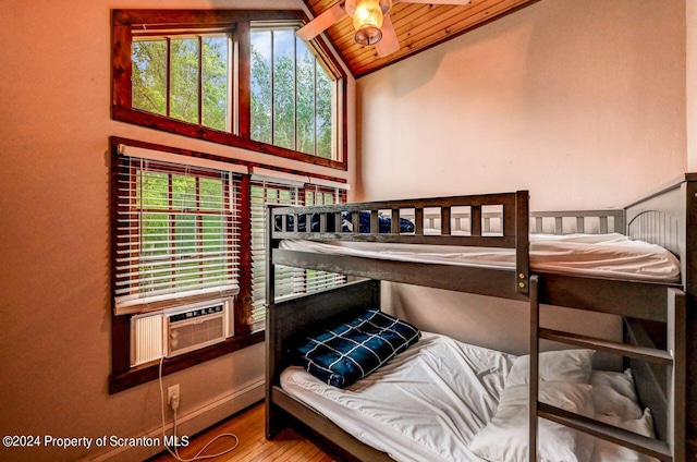 bedroom featuring wood-type flooring, lofted ceiling, multiple windows, and wooden ceiling