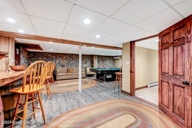 rec room featuring a paneled ceiling, a baseboard heating unit, an AC wall unit, light hardwood / wood-style flooring, and pool table