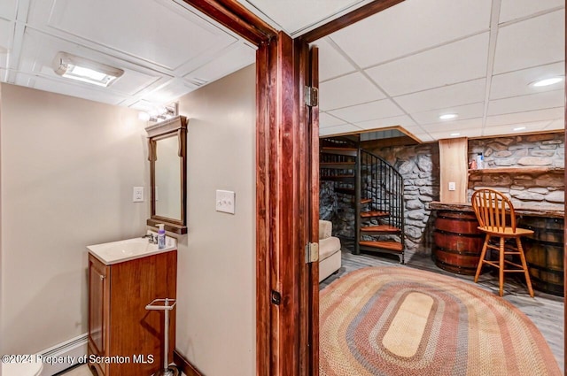 bar featuring sink and a baseboard radiator