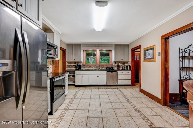 kitchen with sink, decorative backsplash, light tile patterned floors, ornamental molding, and appliances with stainless steel finishes