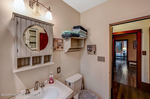 bathroom with sink, hardwood / wood-style floors, a baseboard radiator, and toilet